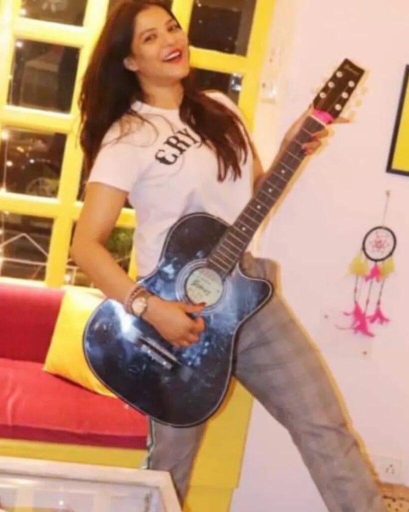 Arpita playing guitar on her teenage