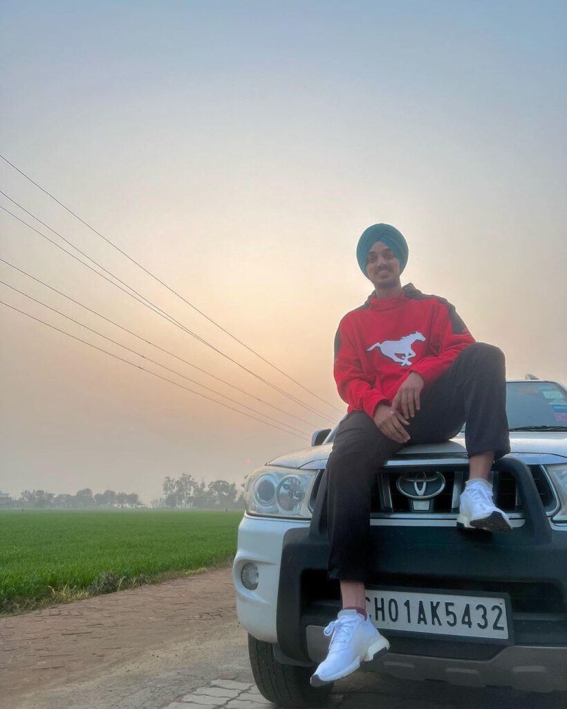 Arshdeep Singh sit on his Toyota Fortuner car
