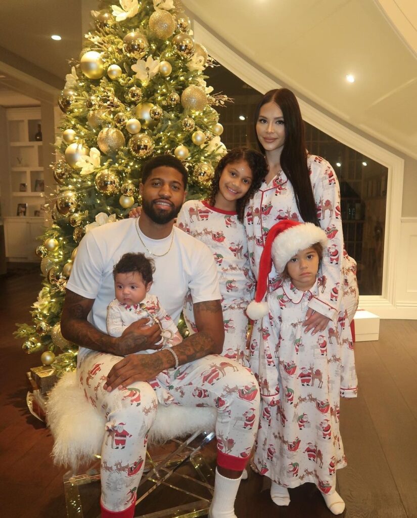 Paul George with his wife and children