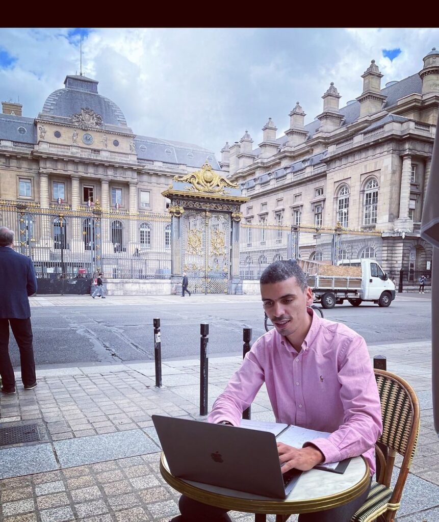 Mourad Battikh doing work on laptop
