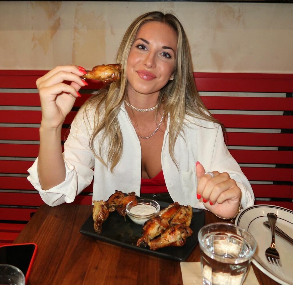 Erin Dolan eats chicken on vacation