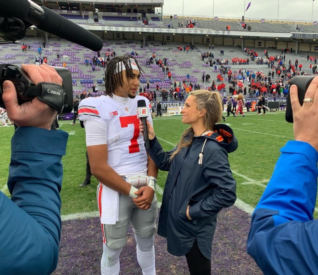 Molly McGrath with football player taking interview