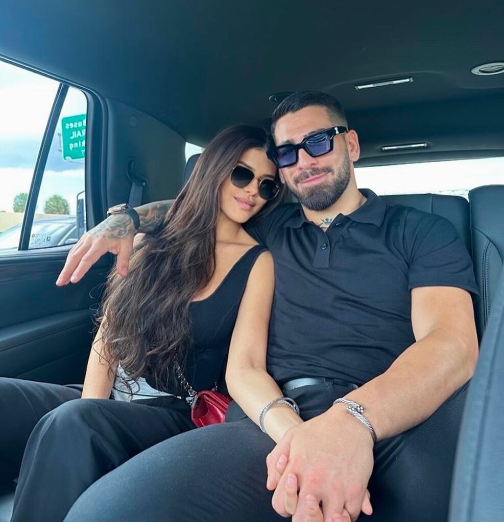 Giorgina Uzcategui in her luxury car with her partner