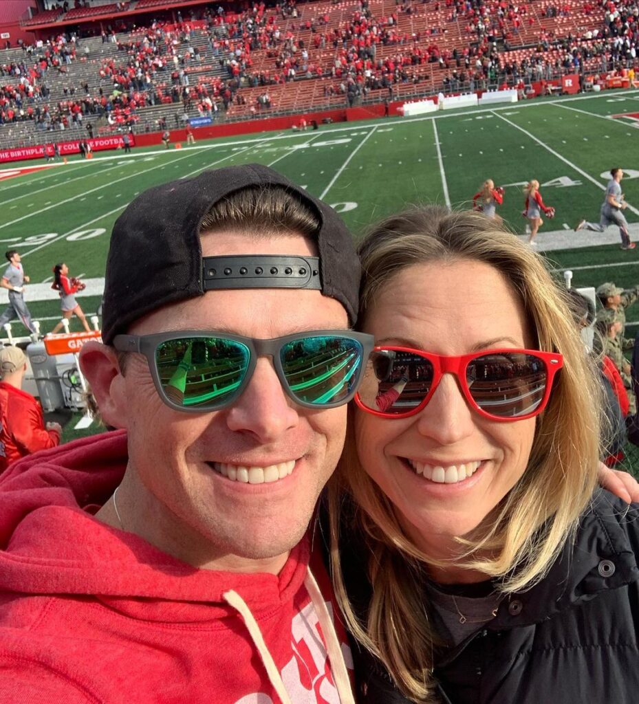 Phil Mattingly with his wife in football stadium