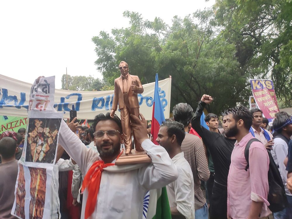 Protesters hold up a statue of Dr B. R. Ambedkar at the Jantar Mantar demonstration in New Delhi