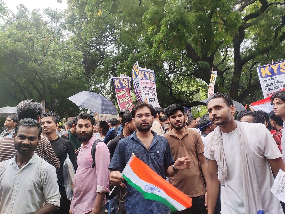 Young Indian protesters with a national flag at the Cockroach Janta Party backed demonstration in New Delhi